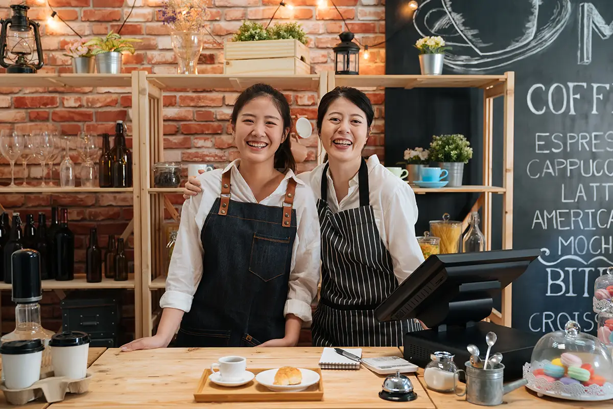 Two woman in aprons who are happy after using Welly.